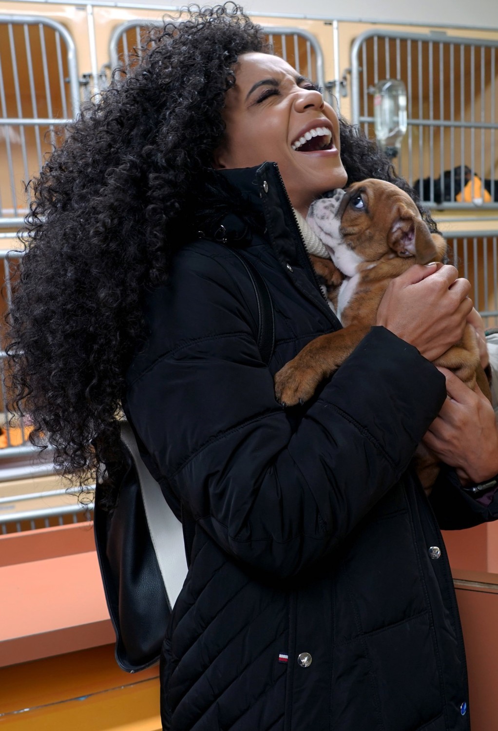 Cheslie Kryst laughing with a bulldog puppy